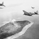 US Navy Douglas SBD-5 Dauntless dive bombers of bombing squadron VB-16 flying from USS Lexington (CV-16) attack Japanese installations on Param Island, Truk Atoll in February 1944 (US Navy)